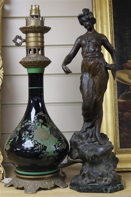 A glass and brass lamp and a spelter figure